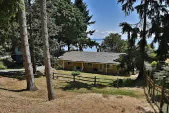 View from the road. One lovely feature of this home is that it has both a front yard and back yard.
