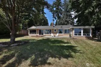 View side of your home. Plenty of windows to maximize your view and bring in the light! Windows to the far right belong to the sunroom in your Primary Suite. Window to the far left belongs to the kitchen.