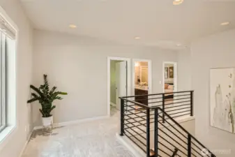 Second level hallway is extra large with space for seating