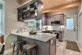 Custom kitchen is fully applianced and designer cabinets feature a Lazy Susan, spice rack, pull-out cabinet drawers, trash & recycle drawer & dish rack.