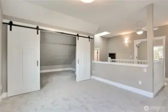 Loft/den area with barn doors and huge storage area.