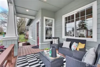 Front covered porch with seating bench and planters. A truly custom craftsman architectural detail.