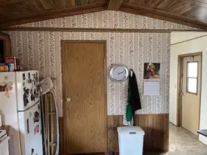 Door to wash/dryer/ht. water heater & storage.