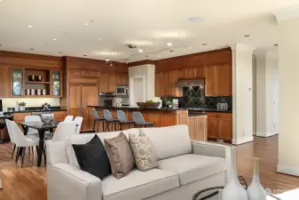 The cozy space connects to the gourmet kitchen and informal eating area.