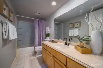 The full hall bathroom also features Corian countertops.