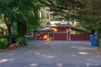 Large shop with another covered wing shown to the right, and ample parking in the driveways on either side of the house. The shop also has a sink in it to wash up while you're tinkering with your projects.