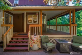 You have multiple outdoor living spaces around the fenced backyard.  This one is perfectly situated near the covered deck, this incredible place is perfect for relaxing or entertaining inside and out.