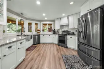 Dream kitchen, anyone? This completely remodeled kitchen boasts gorgeous floors, cabinetry and granite countertops, complete with a huge farm-style sink. The stove is plumbed for propane or electric.