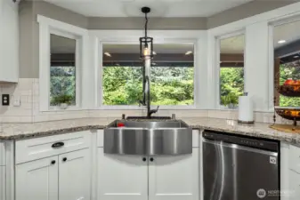 Talk about relaxing while you're in the kitchen, it has a Zen feel to it with french door access to the wrap-around deck just to the left of this photo.