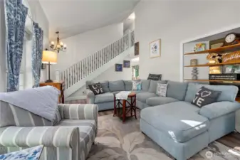 Here's another view of the front living room with beautiful new flooring and custom open rail staircase leading to the 3 upstairs bedrooms.  You also have 2 bedrooms, an office space and a full bath here on the main floor, as wel as a 1/2 bath in the laundry room.