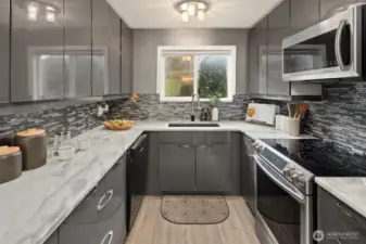 Stainless Steel appliances, Streamlined cabinetry, Granit Counter tops.  Plenty of storage and pantry to the right near the laundry nook.