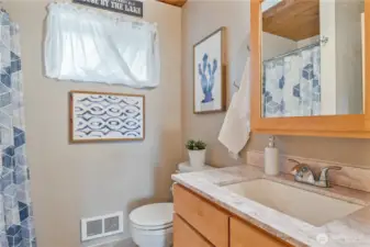 Bathroom with newer vanity and solid surface countertop