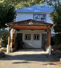 French door  opening from carport/ garage into lower level