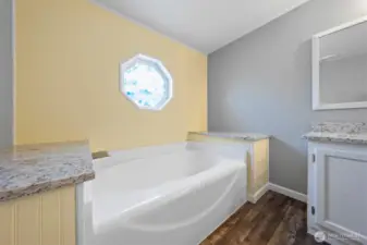 Relax and unwind with a warm bath in the new master soaking tub, complete with granite side shelves. Place fragrant candles on the ample shelves to ease tension after a long day.