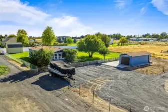 This property offers ample parking for various vehicles and recreational equipment, making it ideal for those with a passion for outdoor activities and multiple vehicles.
