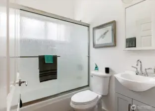 Upstairs shared bath is between the primary and second bedroom w/ tub and shower.