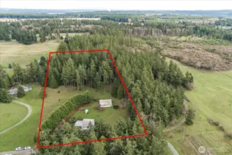 Approximate lot lines showing paddocks, forest area and barn at  the center of property.