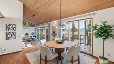 Floor to ceiling glass slider effortlessly brings entertaining to outdoor deck.