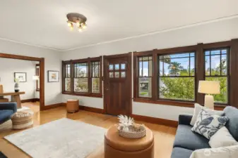Elegant living room with inviting fireplace and lot of great light from a wall of windows facing south