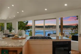 Gas cooktop and large center island with seating.