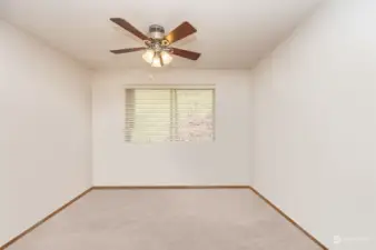 Loft area with ceiling fan.  Furniture has been virtually removed
