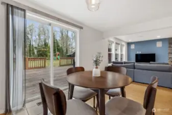 Dining room with a view—of the deck, the big lawn, and the playground structure in the back. This space is more than just a place to eat; it’s your front-row seat to outdoor fun. The sliding glass door makes the transition to alfresco dining easy, and the lawn is just begging for a picnic.