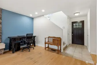 From the contemporary black front door with its upper paned window to the large coat closet, this entry sets the tone for the rest of the home. The tile floor flows effortlessly into the living room, with the staircase adding a graceful transition from one space to the next.