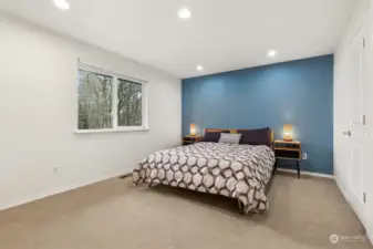 With oak tree views that feel like a natural masterpiece, this primary bedroom blends tranquility with style. Add in soft carpeting and a striking blue accent wall, and you’ve got a space that’s equal parts restful and refined.