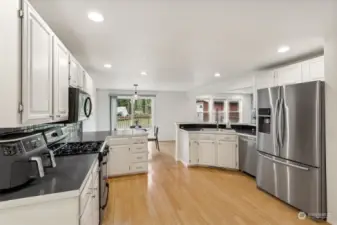 Love this kitchen: sleek white shaker cabinets, dark countertops, and appliances that scream ‘I know what I’m doing.’ Bottom-freezer French door fridge with water/ice dispenser—check. Brand-new dishwasher—check. This kitchen is all about smart design and even smarter living.