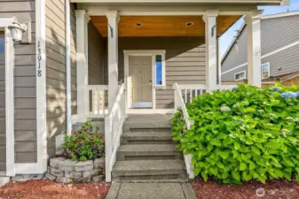 Inviting covered front porch with a touch of Craftsman design.
