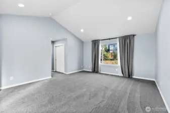 Vaulted ceiling with recessed lighting gives the perfect balance to the soft neutral tones.