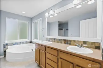 Well-lit luxury 5-piece spa like primary bath designed for ultimate relaxation and indulgence in mind.