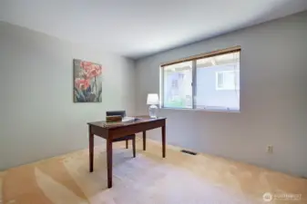 Bedroom 3, or home office. Hardwood floors beneath carpet.