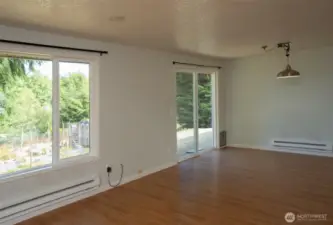 Great room with big picture window and slider to backyard