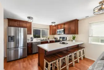 Updates kitchen is beautiful with cabinets and island. Great counter space. Rustic modern light fixtures.