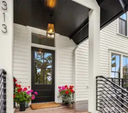 Welcoming front porch with all new decking, railings and cobblestone entry path.