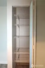 ACROSS THE HALL IS A SHELVED KITCHEN PANTRY!