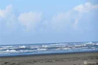 TO THE SOUTH IS A STATUE OF AN EAGLE AND IN THE BACKGROUND IS THE JETTY