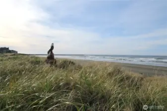 TO THE SOUTH IS A STATUE OF AN EAGLE AND IN THE BACKGROUND IS THE JETTY