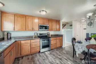 Soft close cabinets and drawers. In the right side of this photo, you'll find a good size pantry closet, half bath & access to fully finished garage where you'll find the front loading washer & gas dryer & 2nd fridge