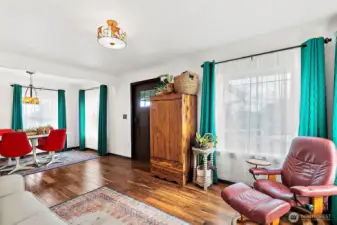 Open layout with the entry flowing into living room and dining room spaces. Large windows bring in tons of natural light.