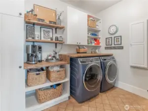 Laundry room with linen cabinets ,folding counter & tile floors