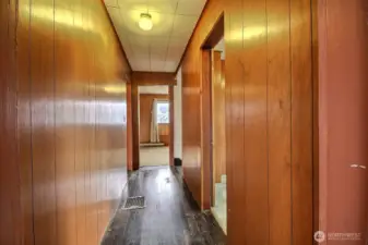 Upper level features wood paneled hallway and original fir flooring.