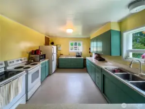 A large kitchen, designed to accommodate events, social gatherings, cooking classes, and everyday meal preparation