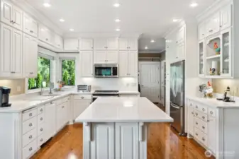 Full compliment of upper and lower cabinets. Pantry and mud room beyond Refrigerator