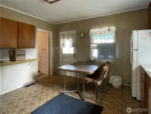 Kitchen connects to the enclosed back porch/utility room