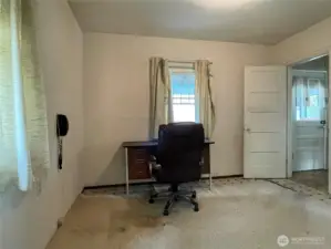 Second main floor bedroom connects to the kitchen and the hall bathroom