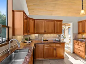 The thoughtful floorplan flows seamlessly into elegant kitchen where you'll find custom cabinetry, maximizing the storage and counter space for all of your cooking and baking needs.