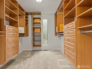 A custom California Closet system maximizes the space in the already spacious walk-in closet. You won't have any problems fitting the most in-depth wardrobe in here.
