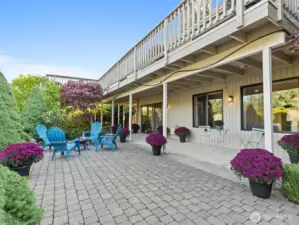 Relax on the sizable patio with covered and uncovered areas, surrounded by the professionally landscaped garden.